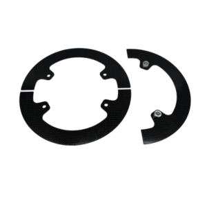 The Gear Guard - 4-Spoke Sprocket Hub - 8.5" Carbon Fiber, featuring a black, circular design, is depicted in two separate pieces with one piece slightly smaller and fitting into the other. There are small holes present for attachment.