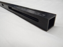 Rectangular black metal measuring instrument with engraved numerical markings from 19 to 23.