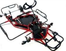 An overhead view of a bare go-kart chassis with red and black metal framing, steering column, and mounting points for additional components.